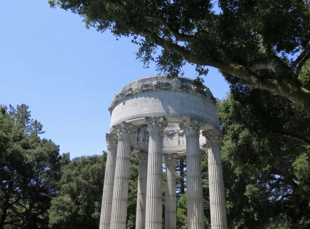 The trees match with the Beaux Arts decorations around the top of the temple. 