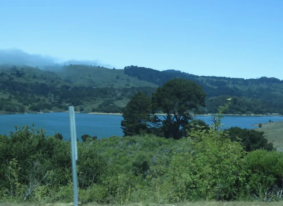 The blue lake of Crystal Springs Reservoir, as seen from the road. 