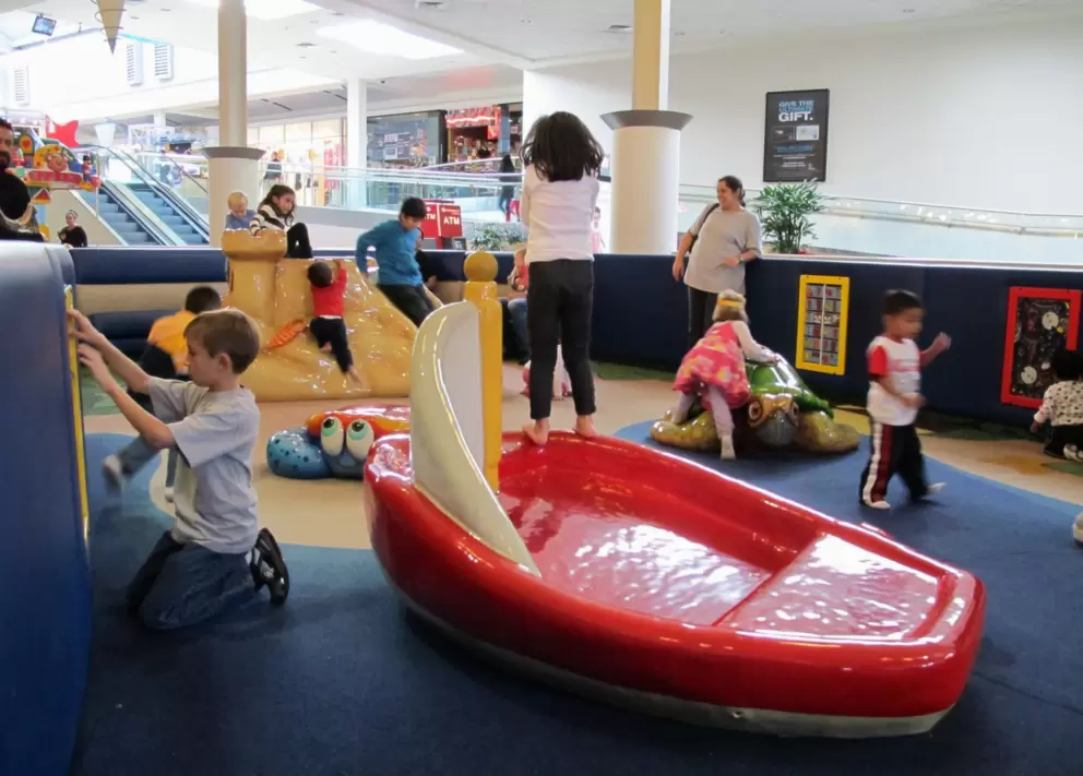 Play area with boat, turtle, crab, volcano, and games along the wall.
