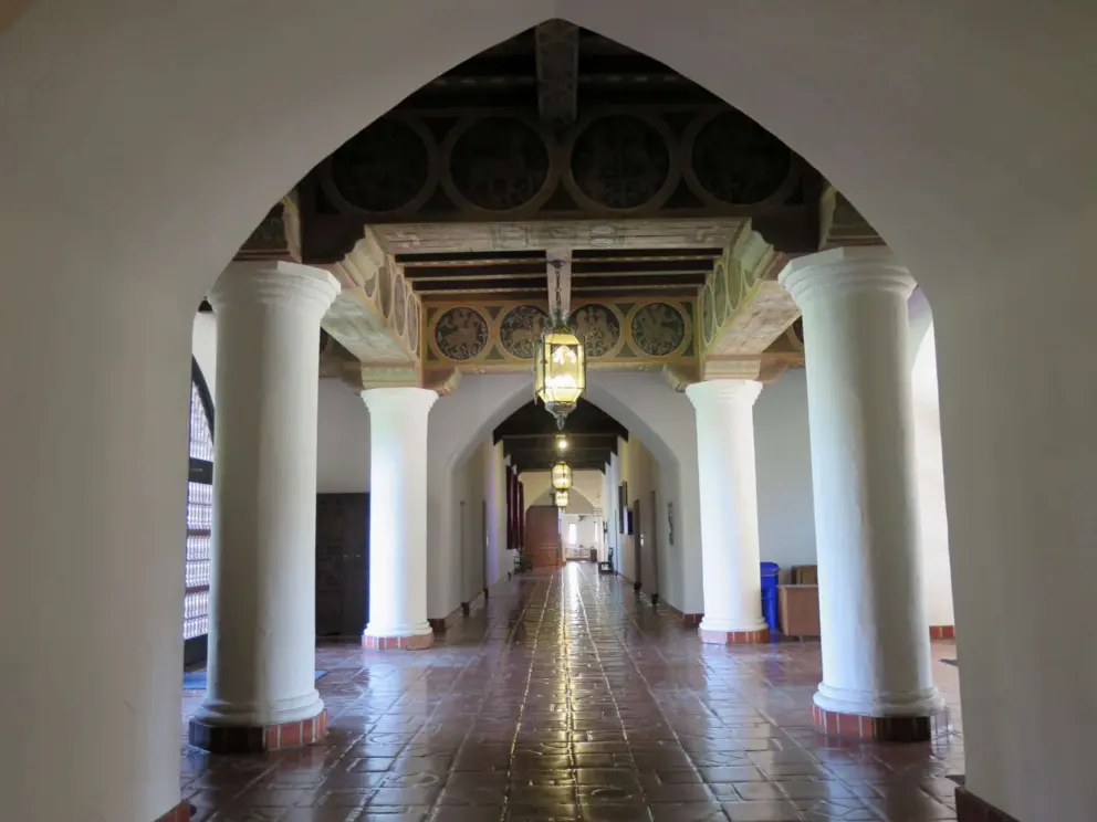 Hallway with glow of lanterns on the Spanish tile floor. 