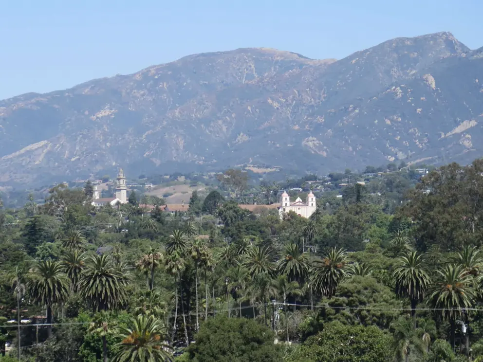 View of the palms galore, former Saint Anthony's Seminary, and the Mission, with high mountains behind. 