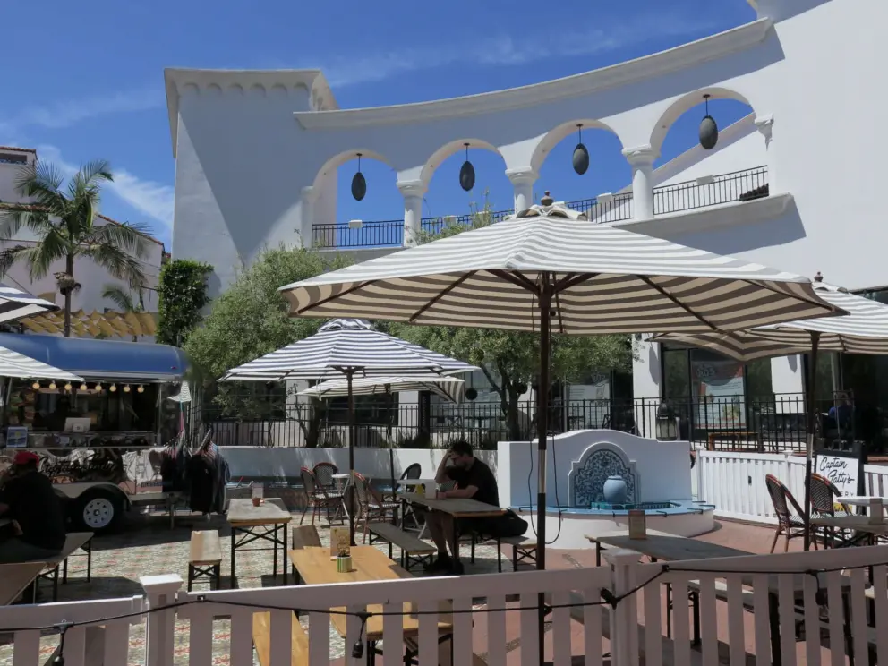 Beautiful arches with lanterns, striped umbrellas, and Spanish fountain. 
