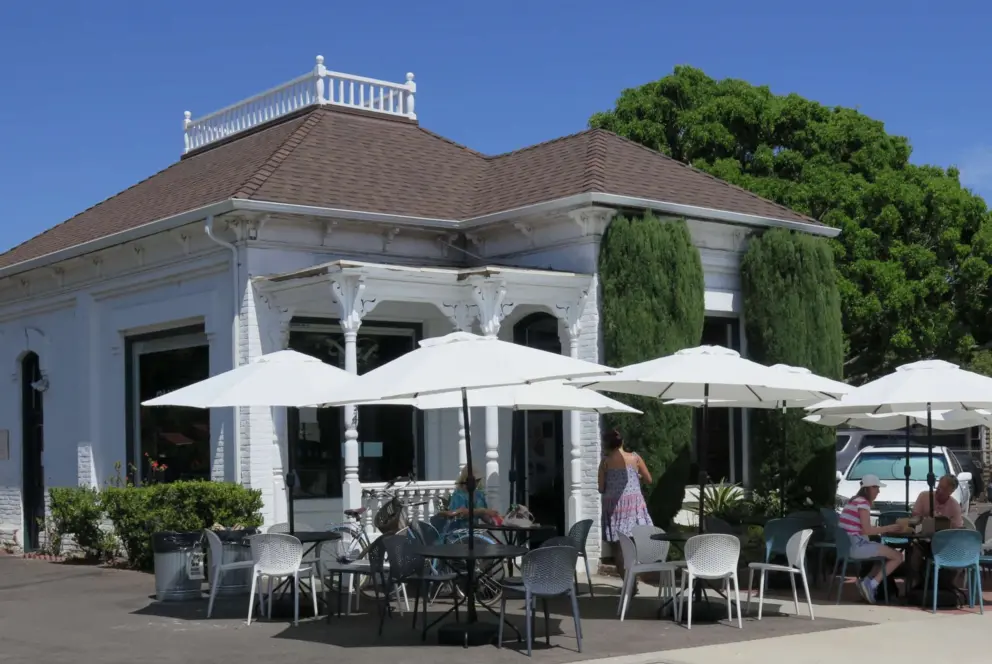 Panino Cafe is nearby, in an adorable historic building with white umbrellas outside. 