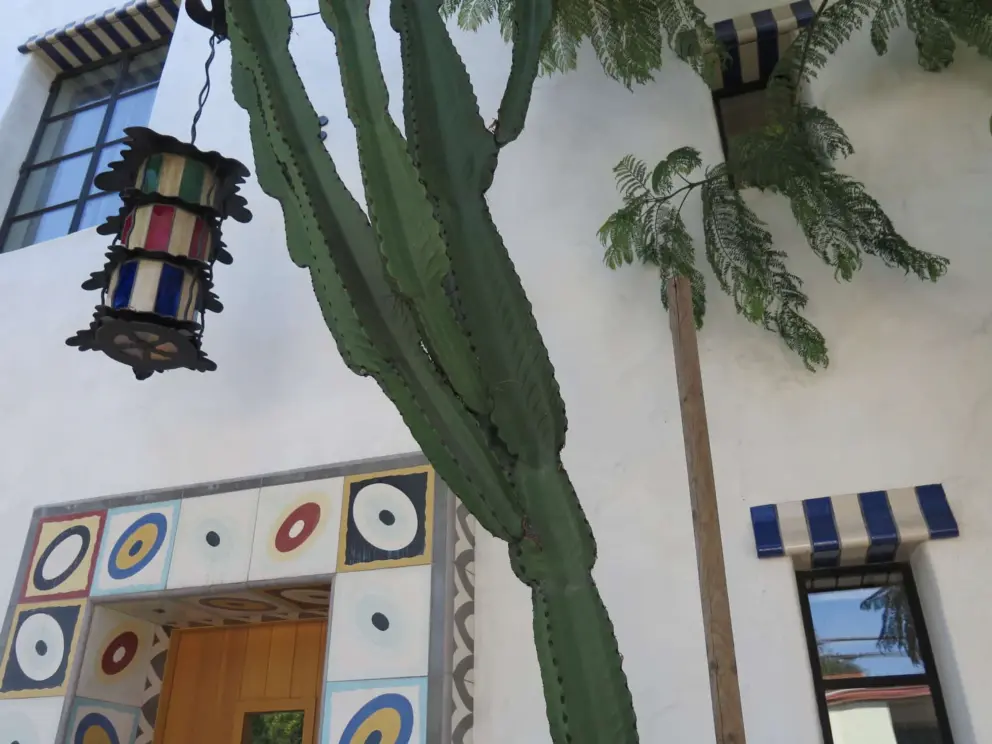 Stripey lantern and window decoration, and door with circles at El Jardin.