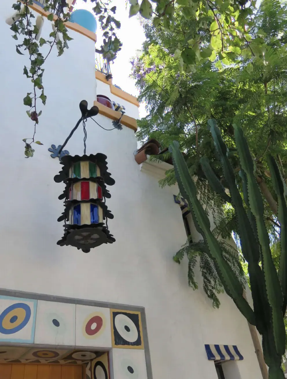 Cactus and vegetation plus white-washed walls and eccentric details at El Jardin.