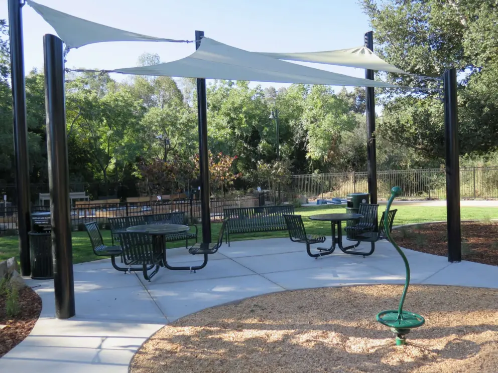 Spinner and picnic tables with shade canopy at North Broad Street Neighborhood Park. 