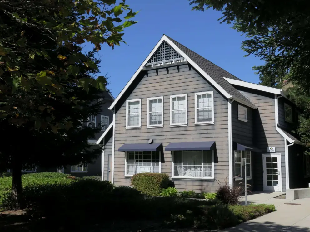 Gray building with white trim, at Avila Village, along the trail.