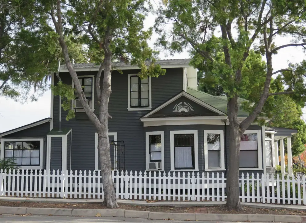 A cute house with white trim.