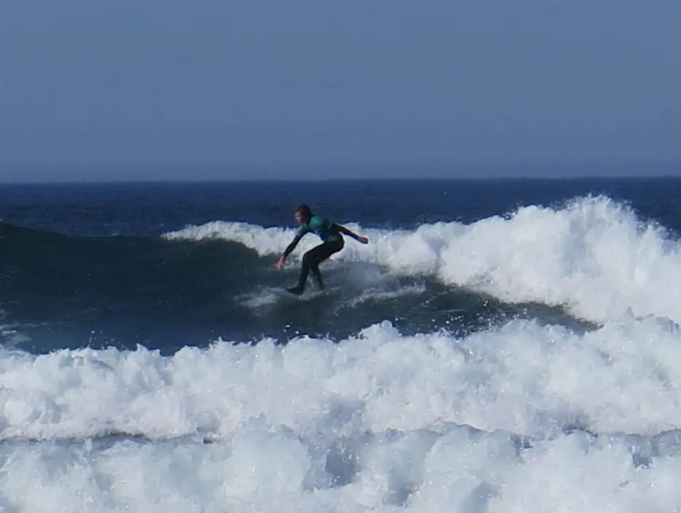 Surfer floating on a wave, at the SLO CAL Surf Contest. 
