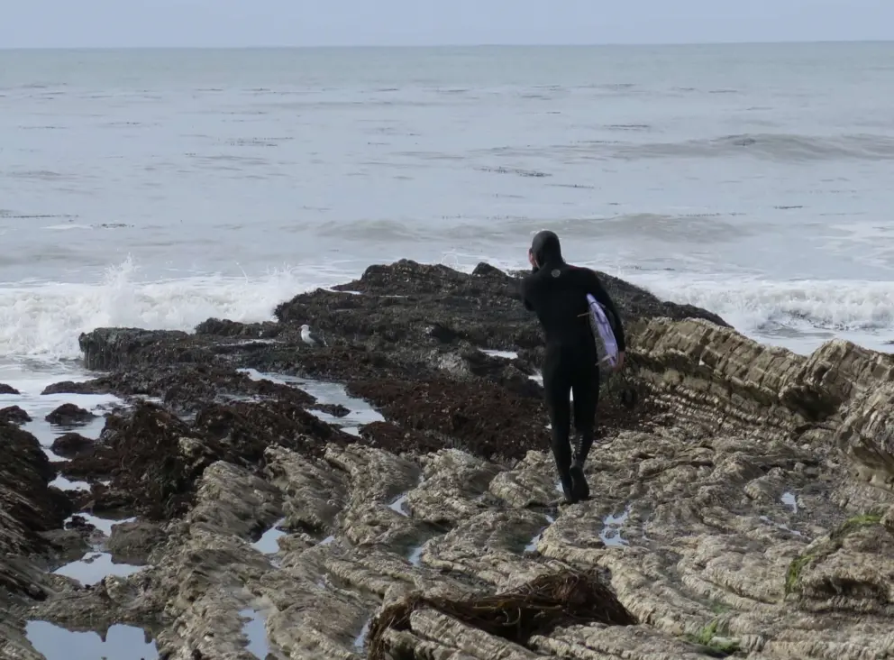 Heading out for a surf at Saint Ann's surf break below Spyglass Park. 