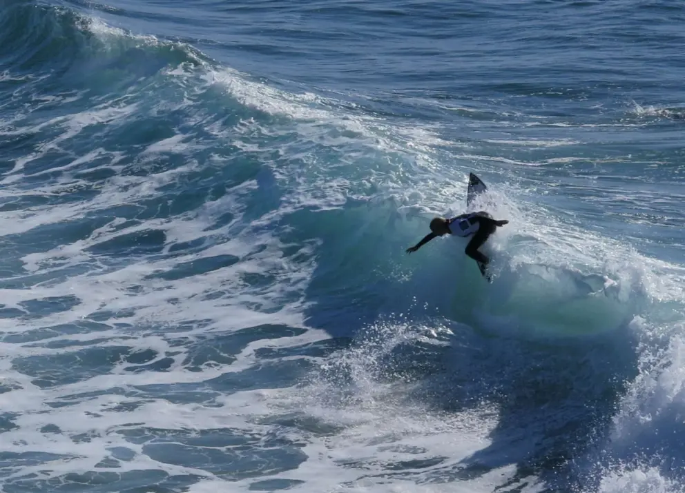 Female surfer catching a wave at the 2025 contest in January. 