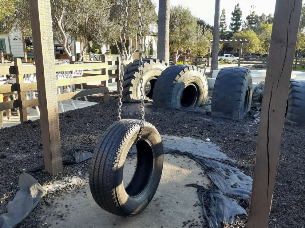 Tire play area for kids. A noisy spot by traffic. I wish it was placed at the main seating area so kids could play while parents eat. 