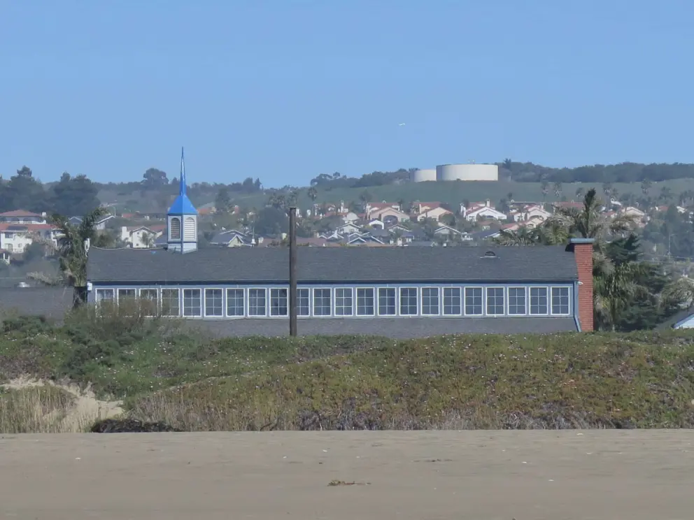 Blue hall with tower, as seen from the creek area of the beach. 