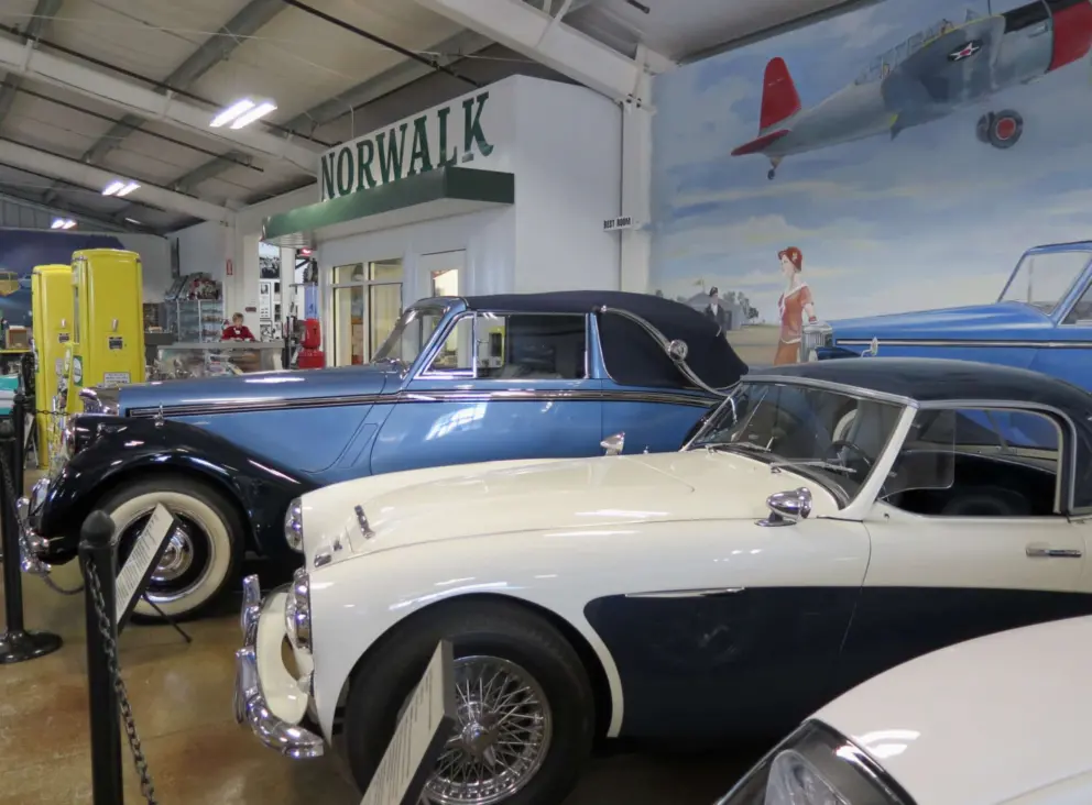 Cars and mural in the Woodland Auto Display building of the museum. 