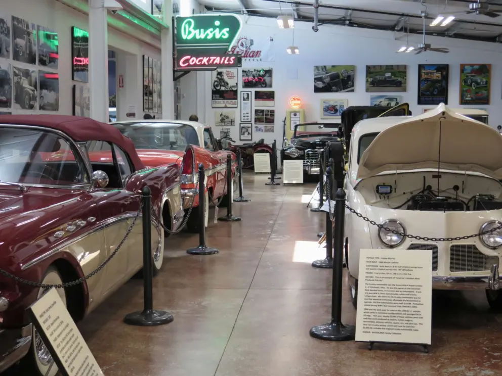 Buick Century Convertible, and Crosley Pick-Up, with neon lights behind. 
