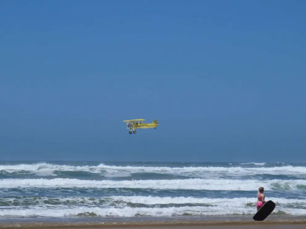 The yellow biplane we saw from the playground, now over the beach!