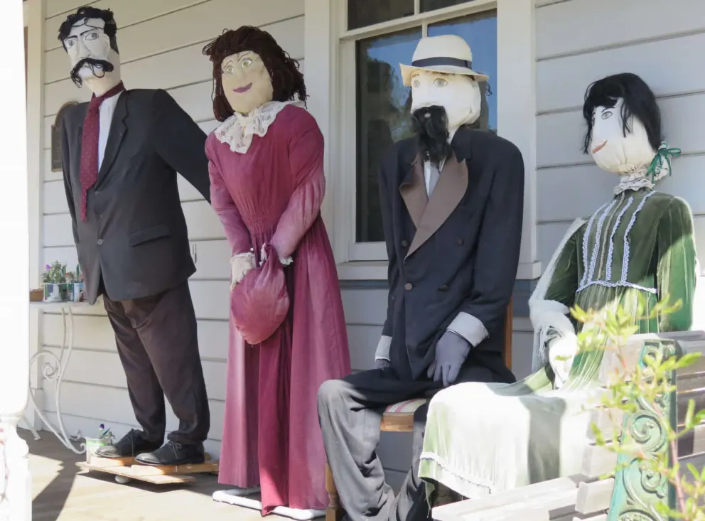 Scarecrows dressed in historic dress on the front porch of the Cambria Historical Society on Burton Drive. 
