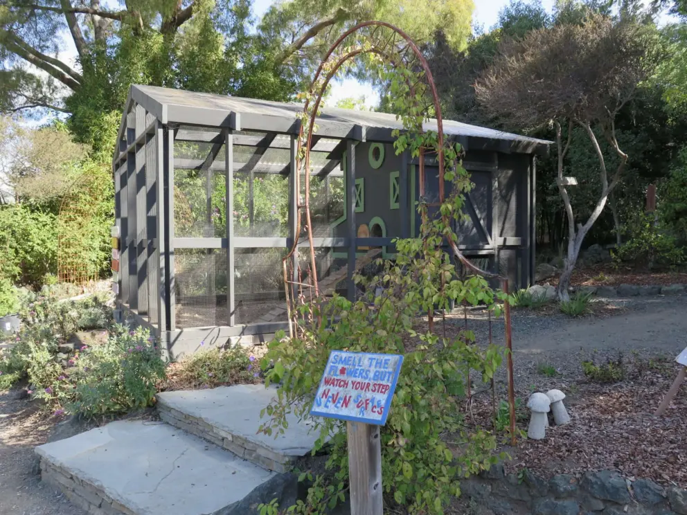 The chicken coop- a red building with green trim.