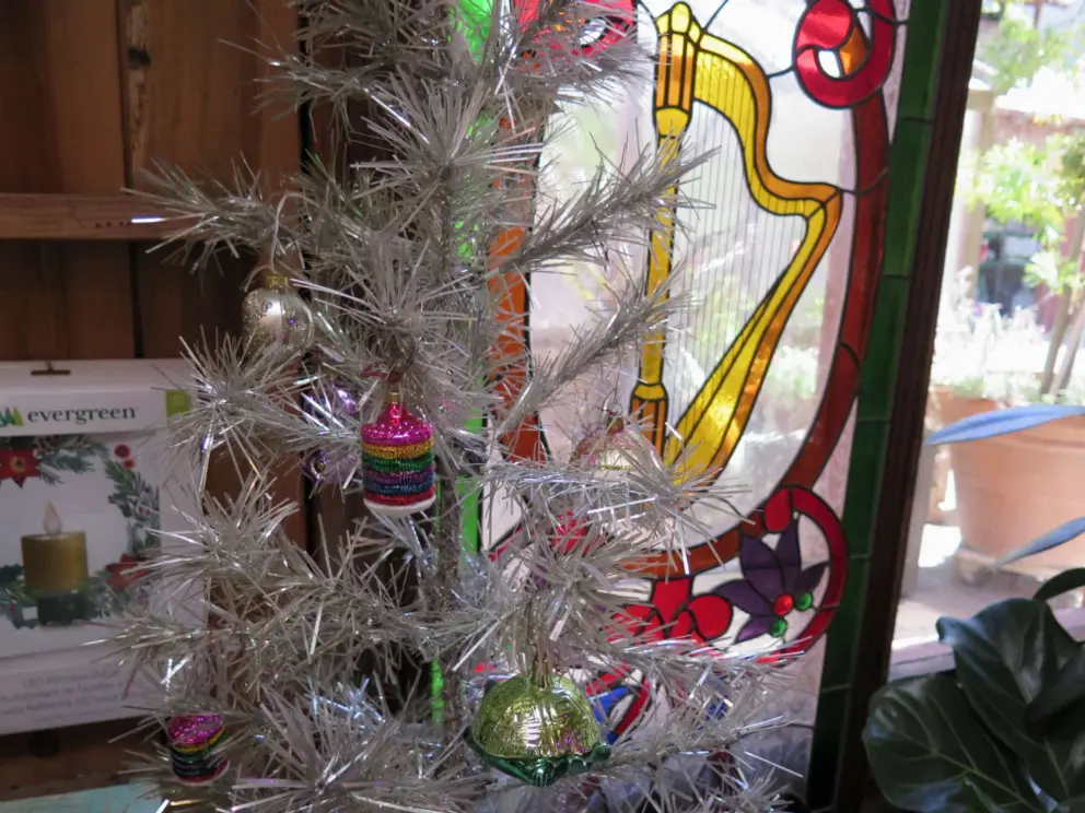 Silver Christmas tree and stained glass with harp. 