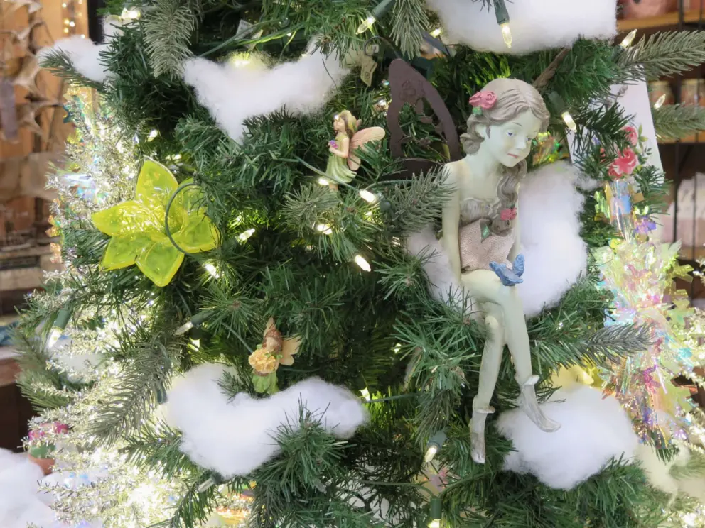 Fairy perched on a Christmas tree. 