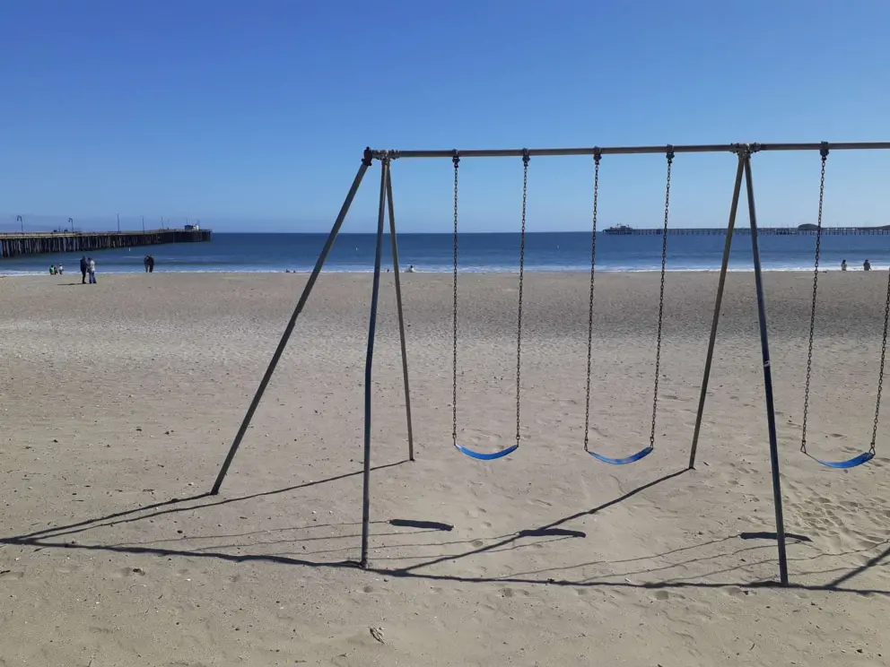 Swings facing the blue sea. 
