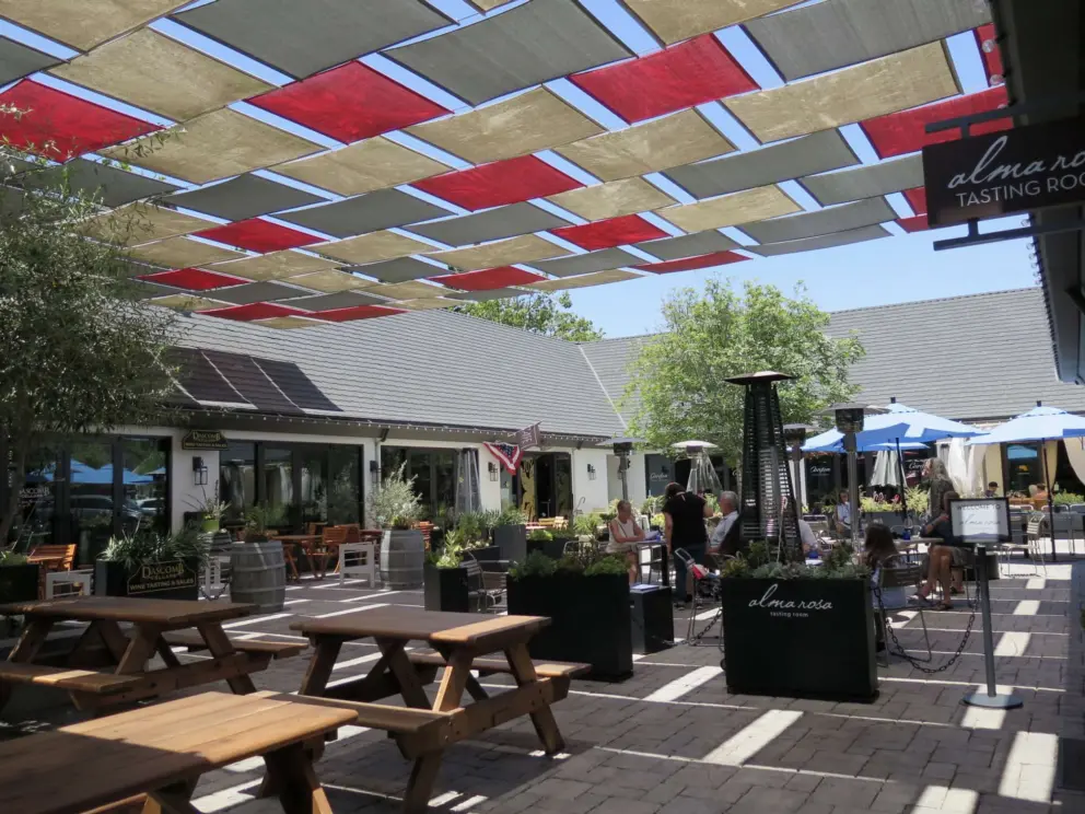 Colorful shade canopy in a courtyard with tasting rooms. 