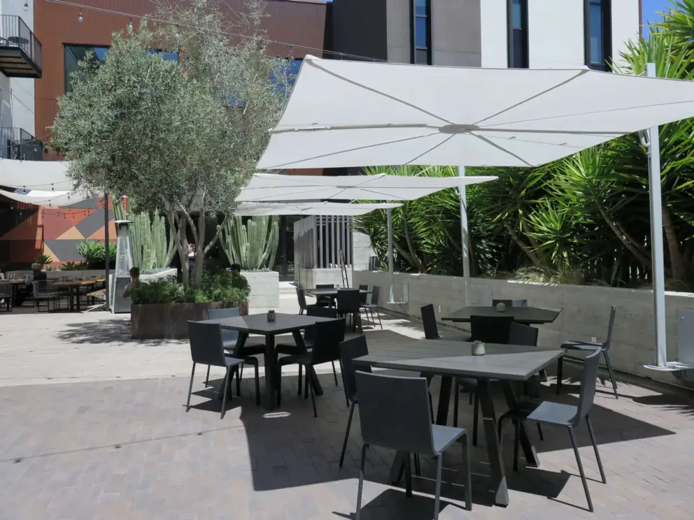 Shaded tables on the lower balcony of Hotel SLO. 