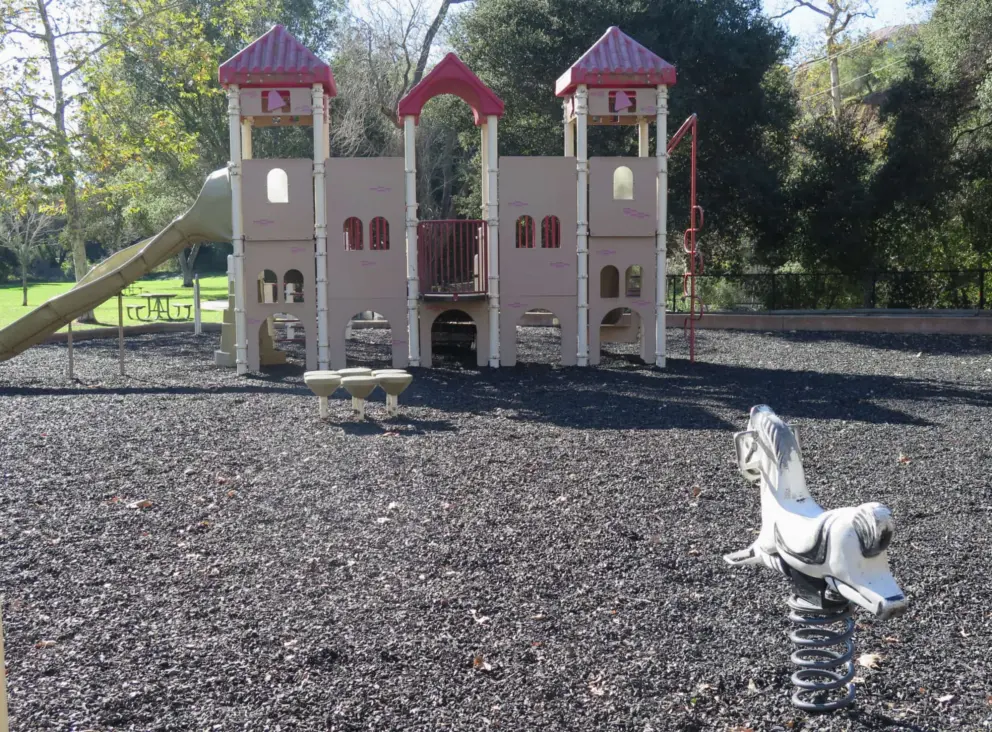 Horse bouncy, and large playground shaped like a California mission with bell decorations in the towers. 
