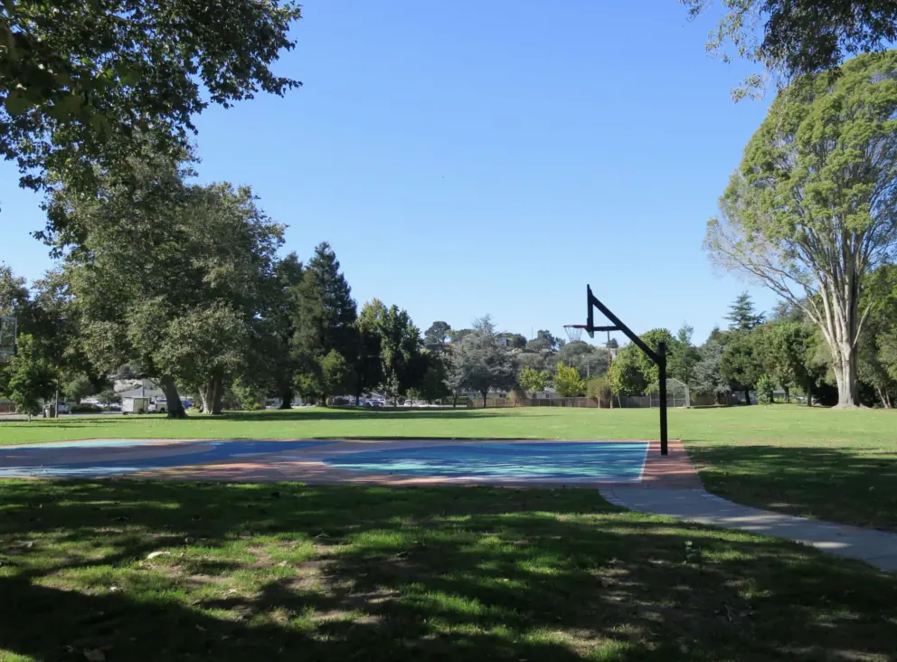 The basketball court and huge lawn with soccer field. 