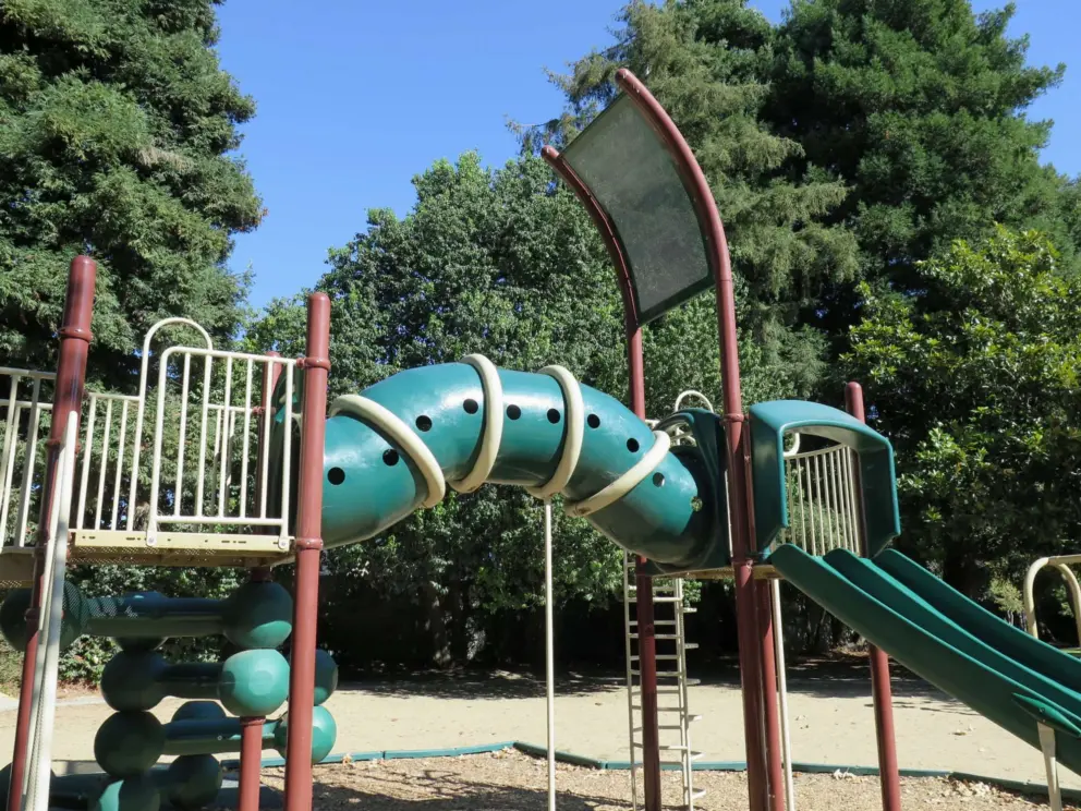 Curved tunnel high up on the playground. 