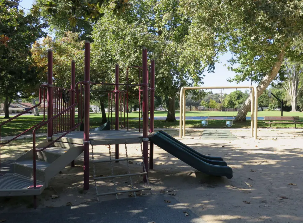 Toddler playground with chain climbey and double slide. 
