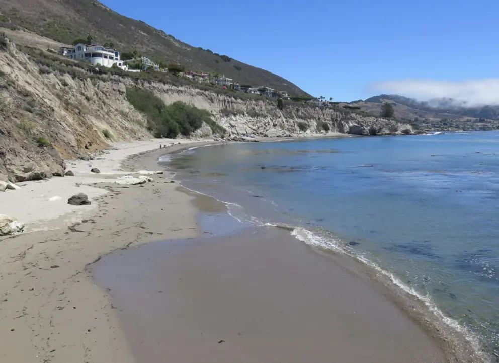 A tiny, clear wave hitting the sand. 