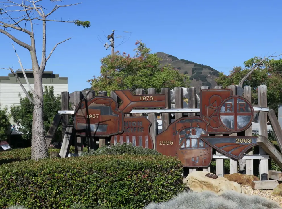 Artwork and view of Madonna Mountain at the entrance to the train station parking lot. 