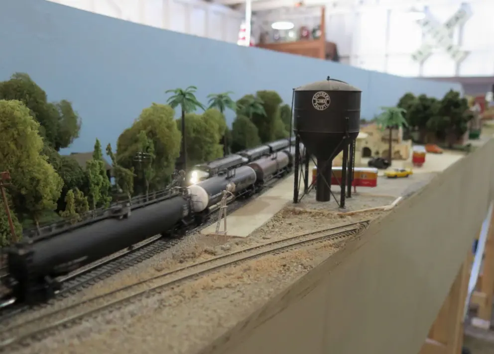 Water tower and oil tanker train in the model railroad. 