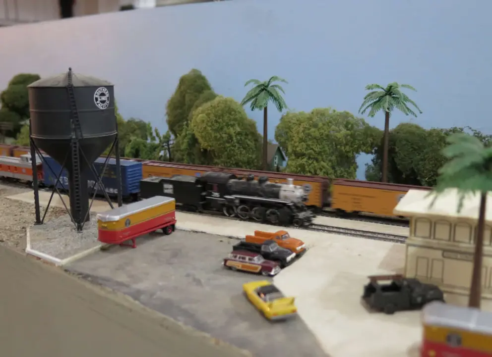 Water tower as a model train speeds by. 