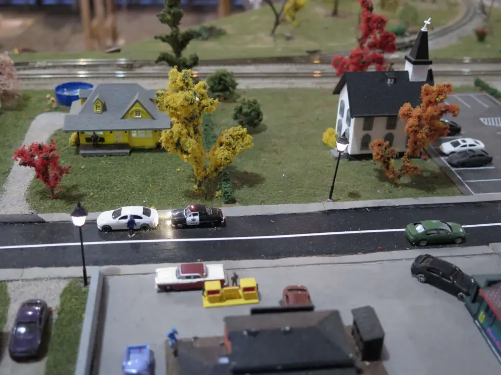 Church, house, and street lamps, in the model railroad. 