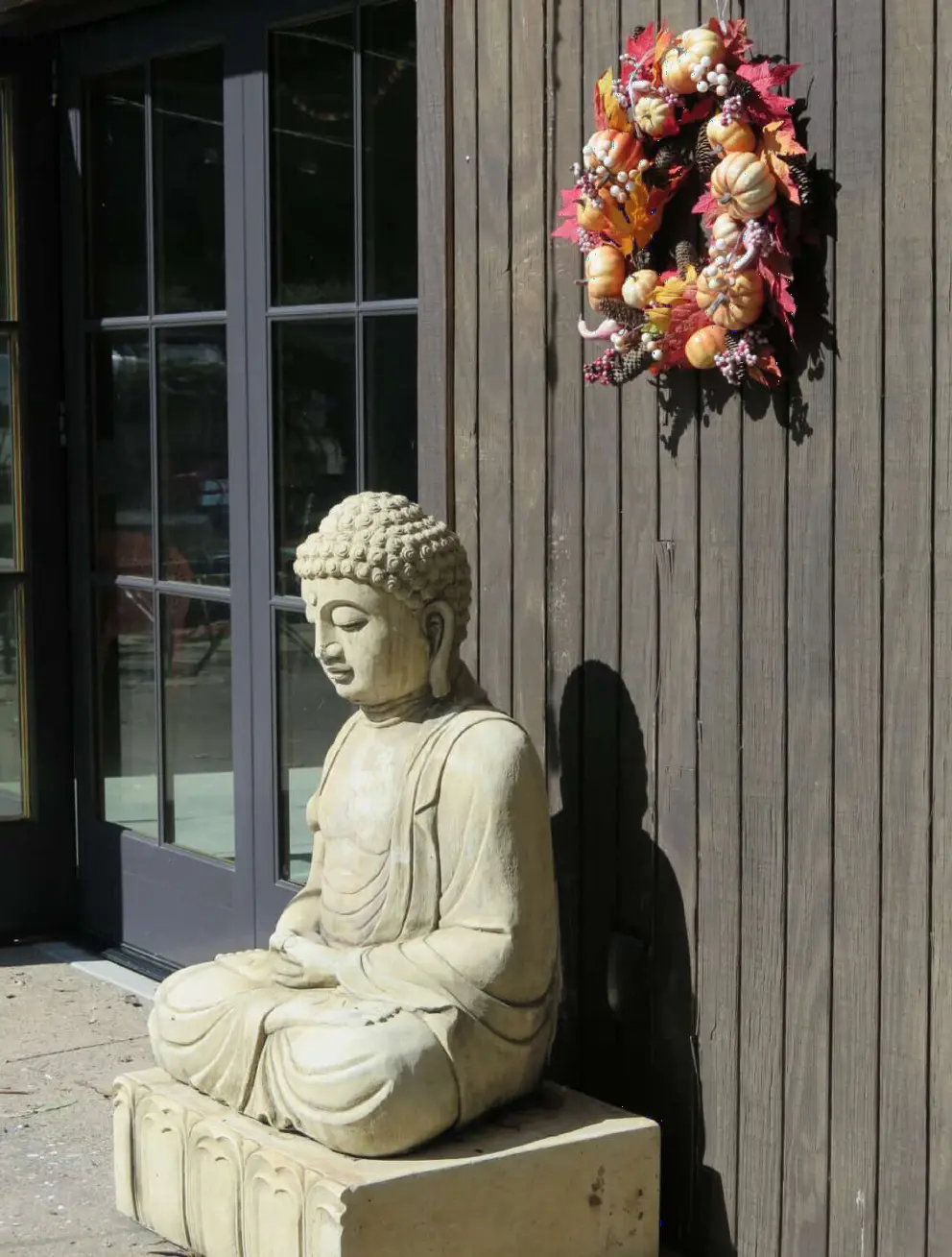 Buddha statue and fall wreath.
