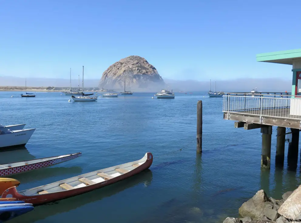 Views of a canoe and Morro Rock, from the walkway. 