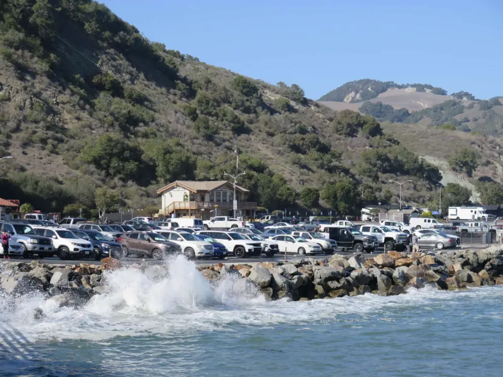 Waves crashing up against the rock wall at the parking lot. 