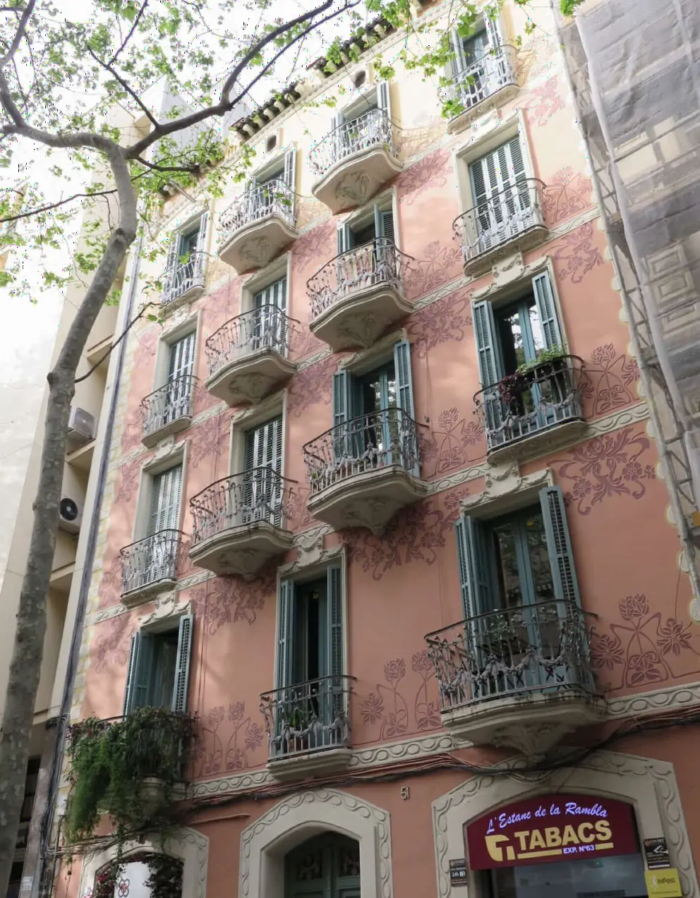 Rambla del Poblenou has this pink building with ironwork balconies. 