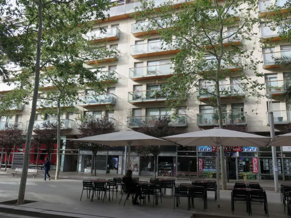 Modern buildings on Rambla del Poblenou, with a cafe in the median walkway.