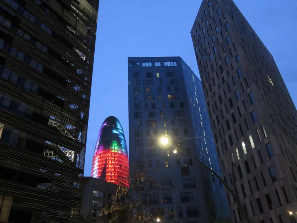 Glories Tower lights up at night in the El Poblenou neighborhood. 
