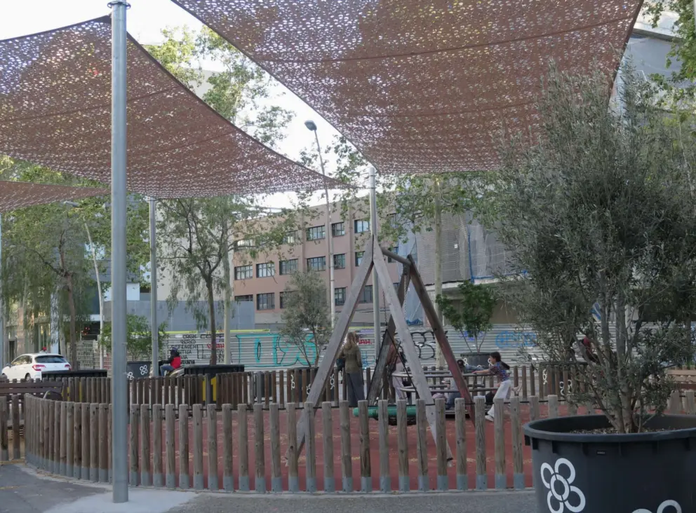 Canopies shade Superilla Sant Marti, a popular playground in the middle of a traffic roundabout. 