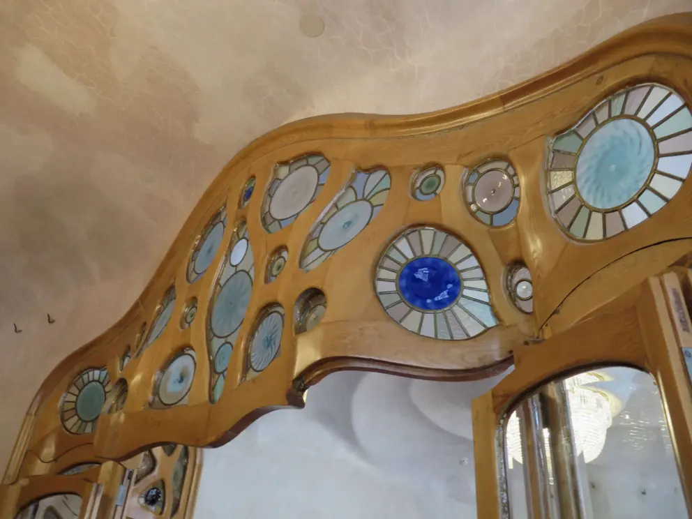 Stained glass and curvy pale wood. 