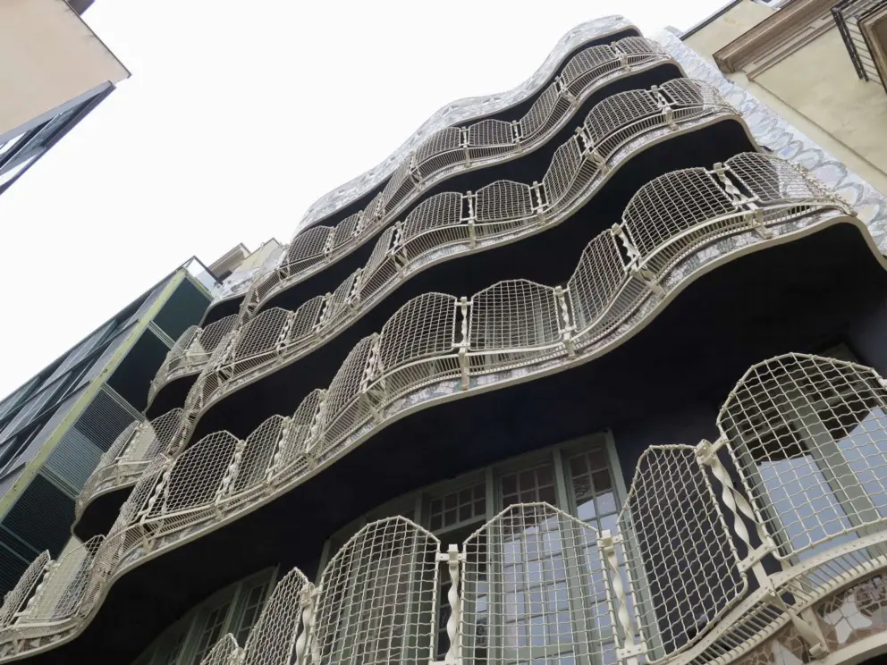 The busy ironwork balconies and windows, seen from the courtyard. 