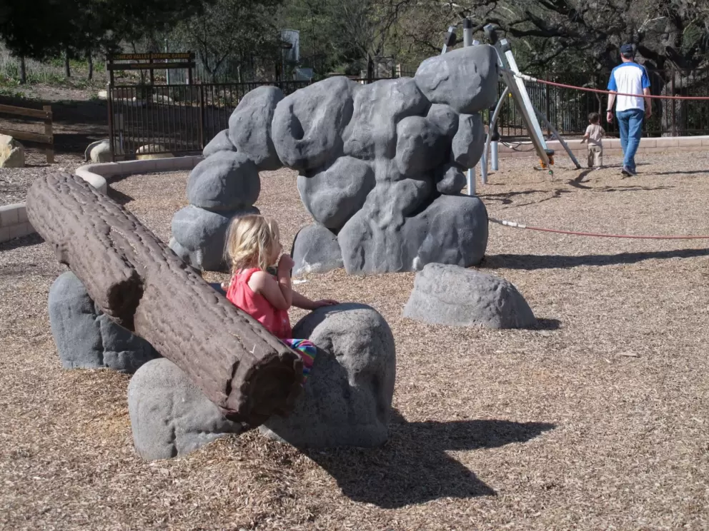 Sitting against the fake log at the playground.