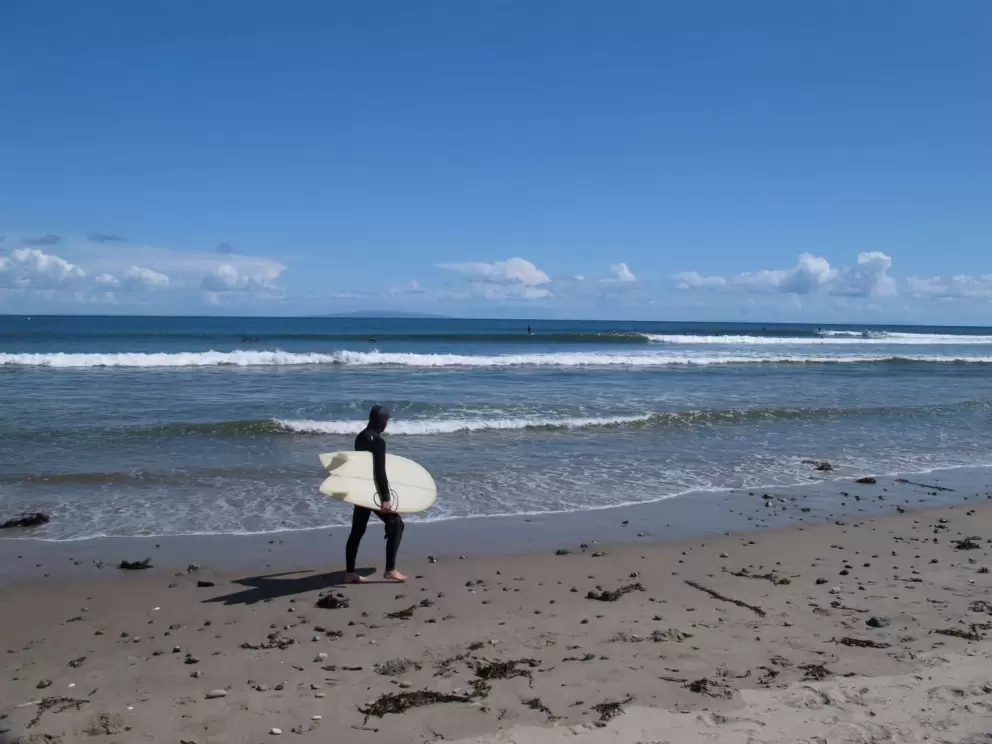 A surfer ready for the cold in April.
