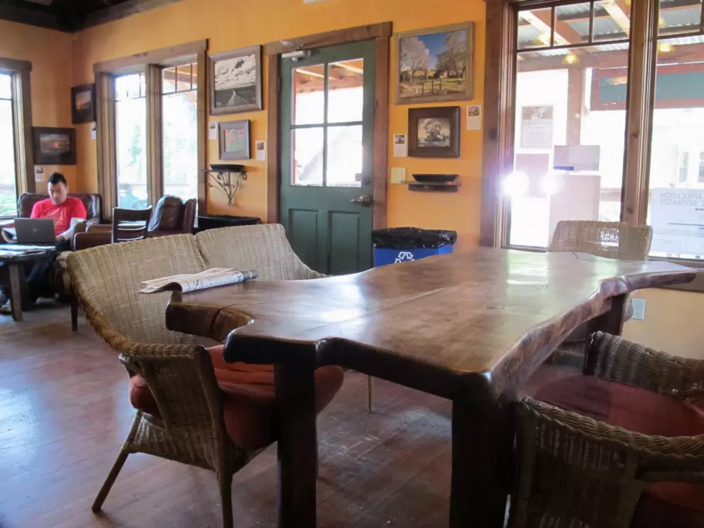 A table made of a slab of tree trunk inside Corner House Coffee- beautiful!