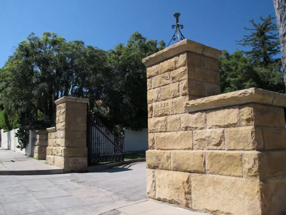 Sandstone gates leading into peaceful Junipero Plaza.