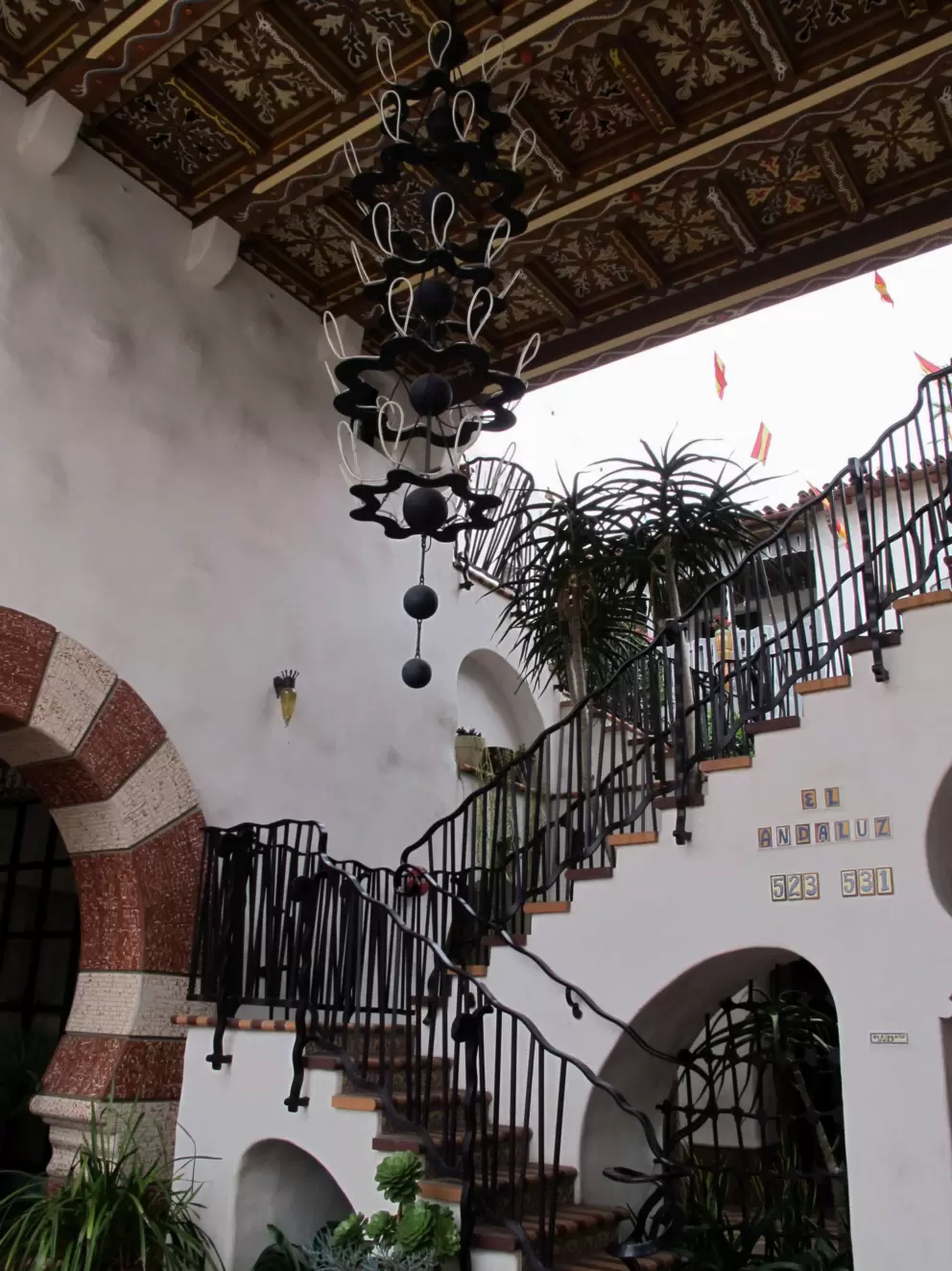 El Andaluz's ironwork stairrail and chandelier.